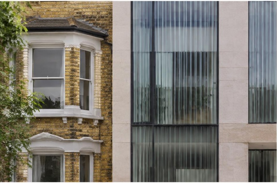 Retained historic facade directly beside a contemporary glazed residential addition in Lambeth