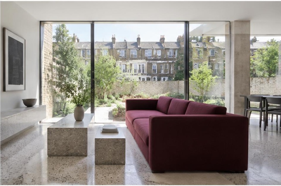 Minimalist contemporary room with straight fabric seating and views onto Lambeth residential homes and gardens