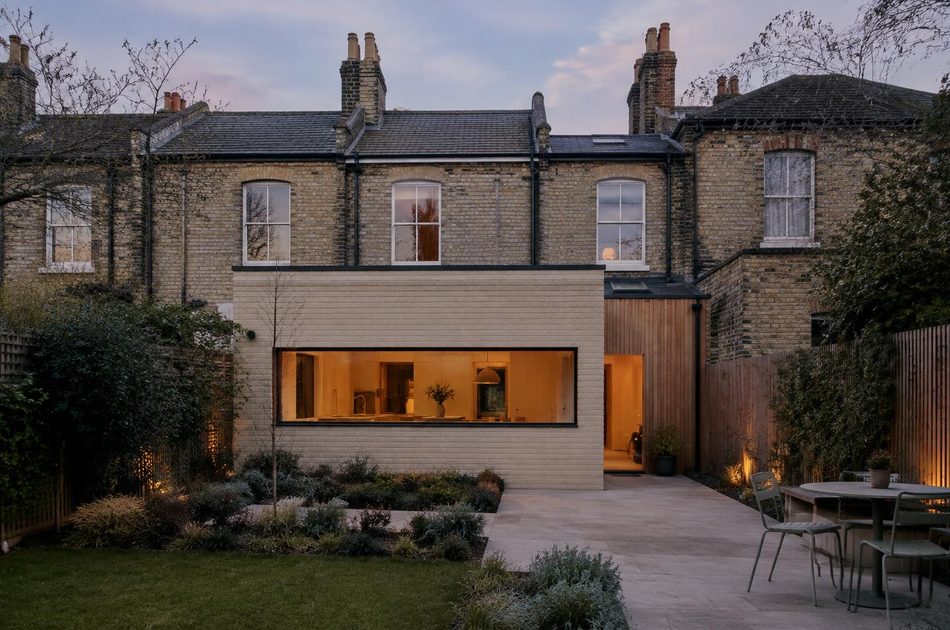 Pale brick and timber rear extension behind Victorian terraces in Lee