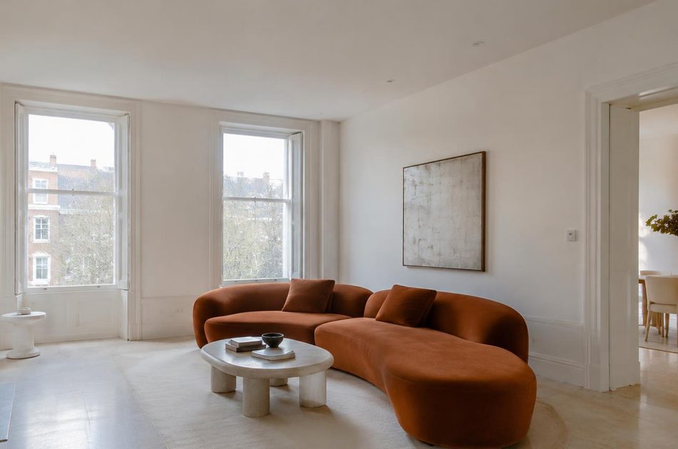 Refurbished Victorian room with a curved terracotta sofa in Lee