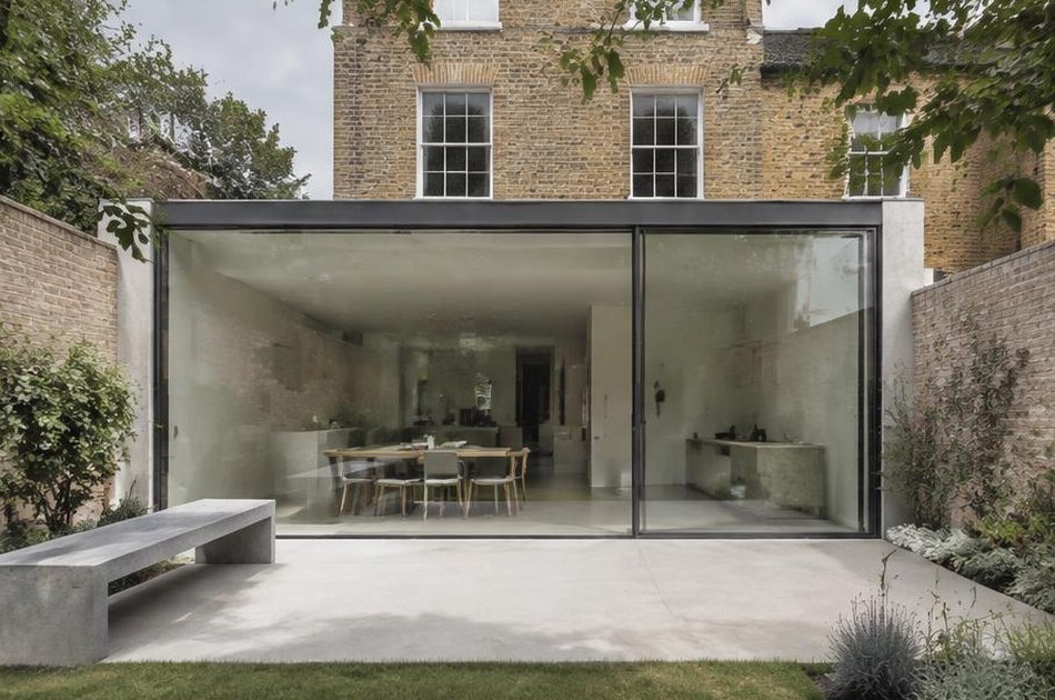 Glass rear extension with a concrete bench onto a garden in Lewisham