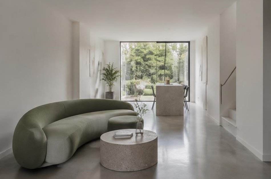 Refurbished Victorian interior with a curved green sofa in Lewisham