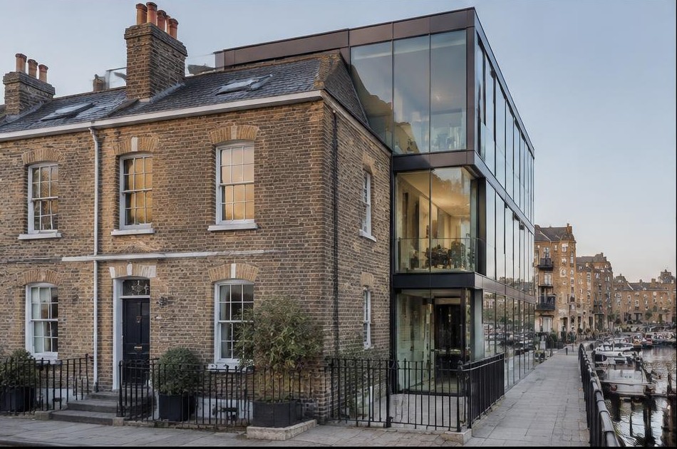 Retained original facade beside a dominant contemporary glazed addition in Limehouse