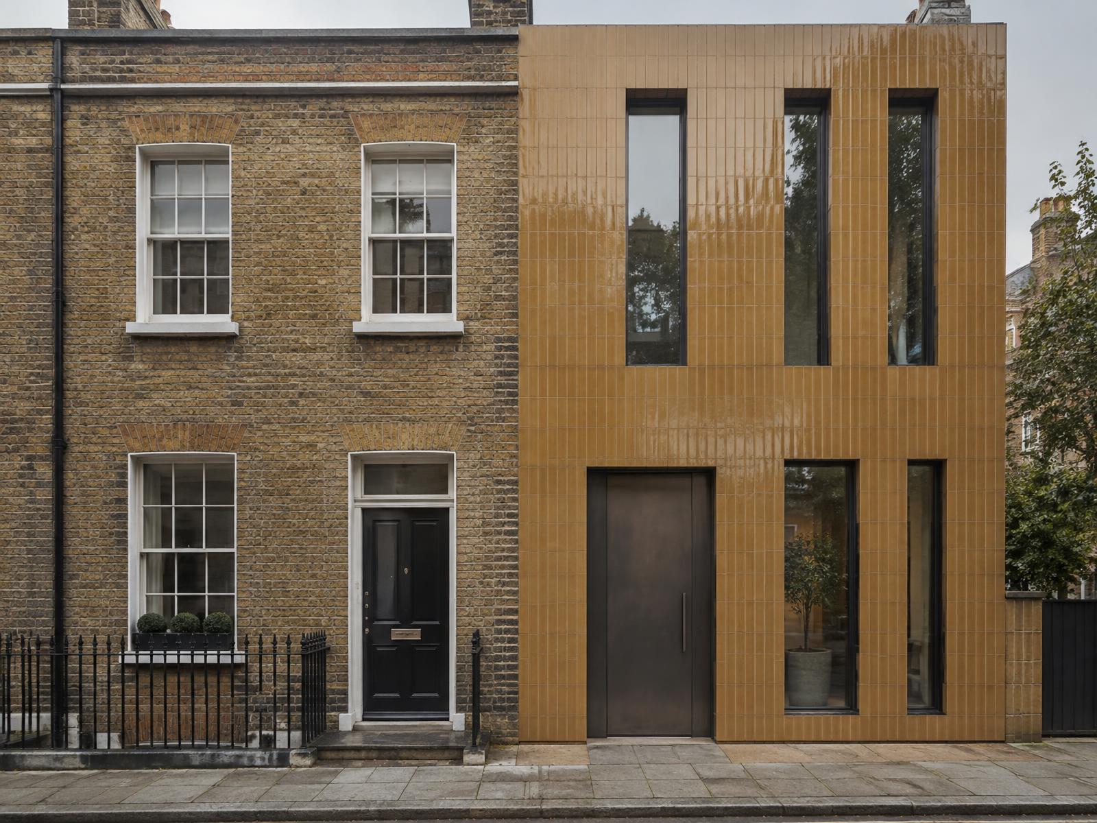 Flat-fronted yellow stock brick Georgian house directly beside a contemporary glazed-tile house of the same narrow plot width