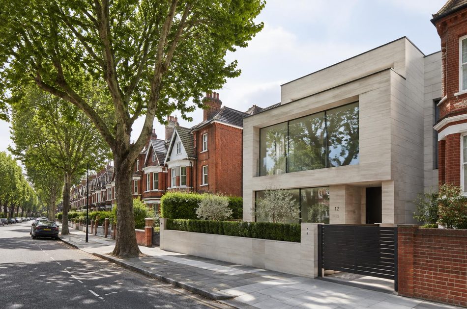 Tree-lined street of Edwardian villas beside a contemporary limestone and glass house in Merton