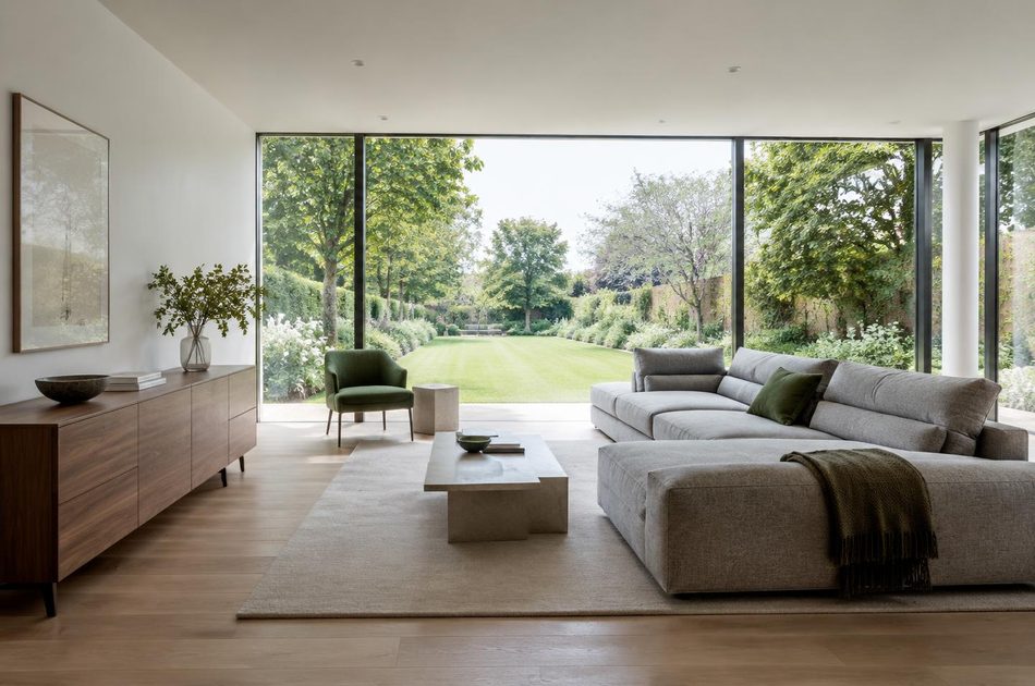Living room with full-height glazing onto a long garden in Merton