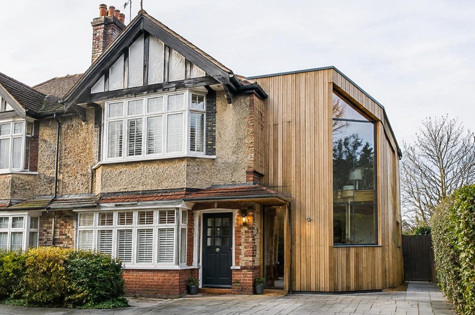 Mock-Tudor interwar semi beside a timber-clad glazed extension in Morden