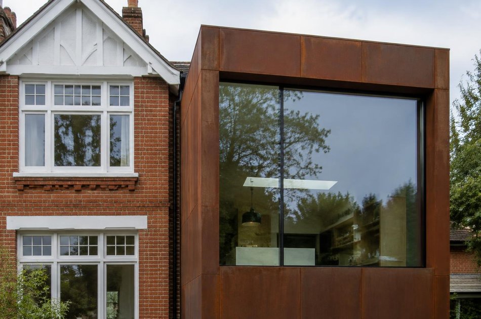 Edwardian gable beside a weathered-steel extension in Muswell Hill