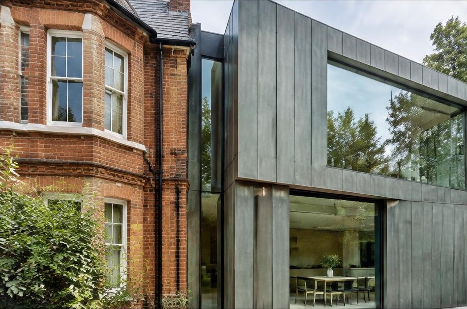 Retained original facade beside a dominant contemporary glazed addition in Norbiton