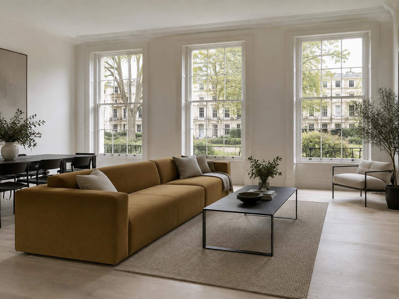 Minimalist flat with a square-edged ochre sofa and sash windows onto a communal garden square