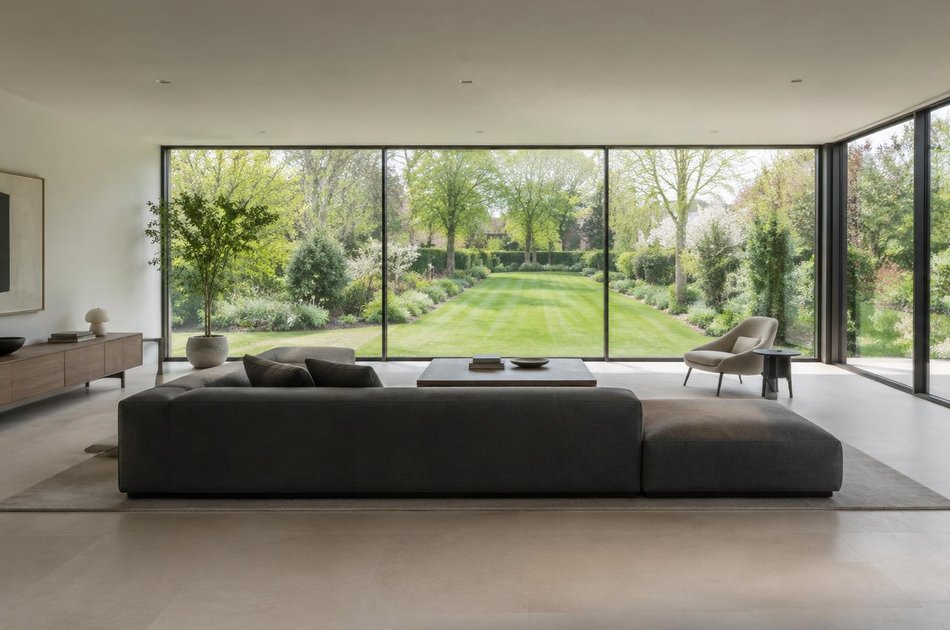Contemporary living space opening onto a garden in Osterley