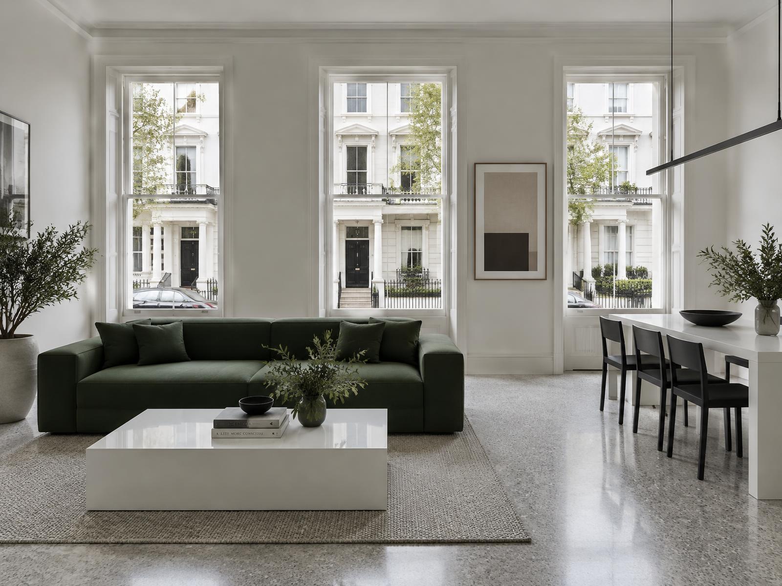 Minimalist terrace flat with a square-edged green sofa and sash windows onto porticoed stucco terraces