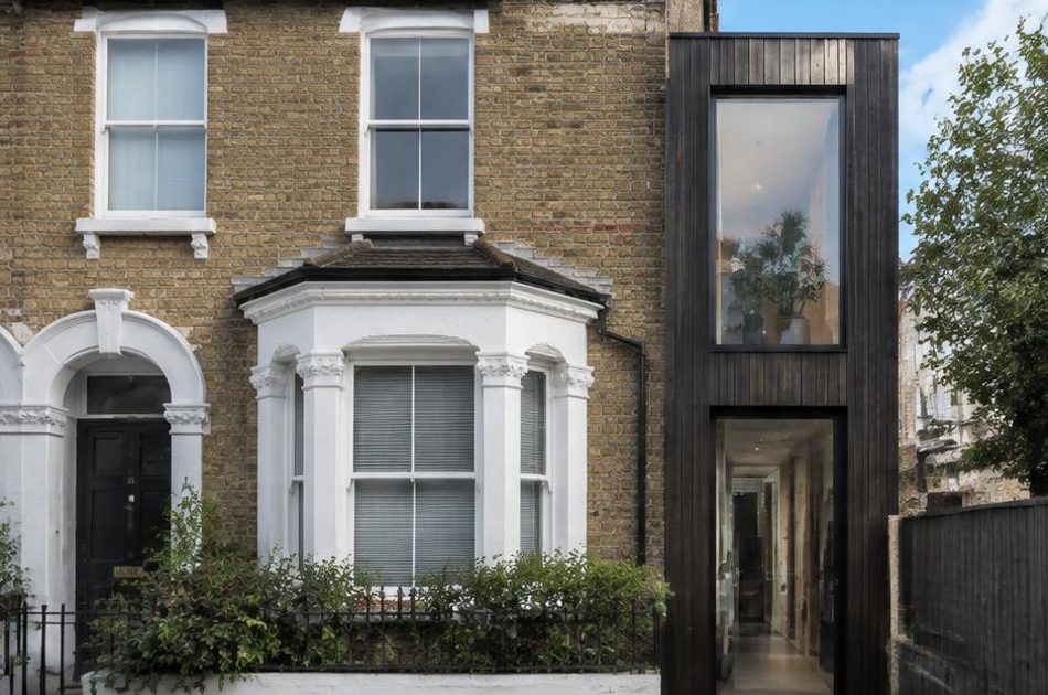 Retained historic facade directly beside a contemporary glazed residential addition in Peckham