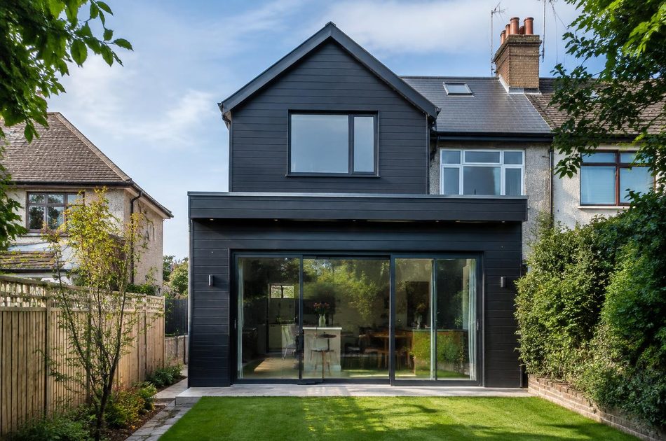 Dark-clad loft conversion and rear extension on an interwar semi in Perivale
