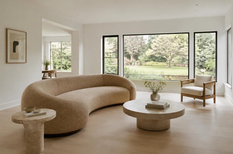 Refurbished interwar living room with a curved sofa in Perivale