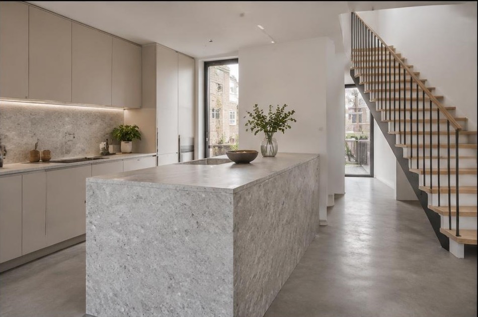 Completed contemporary kitchen with open staircase and garden glazing in Poplar
