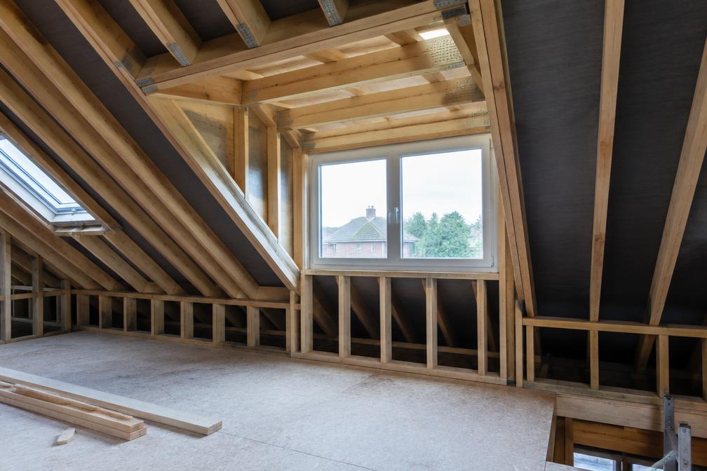 Loft conversion in progress with new rafters and dormer framing