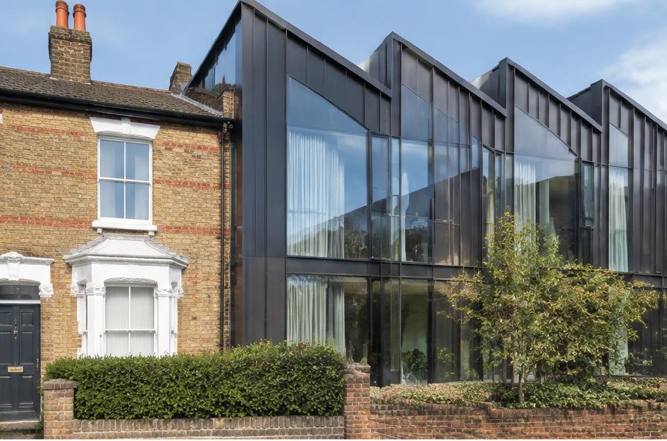 Retained period facade beside a prominent contemporary glazed addition in Sands End