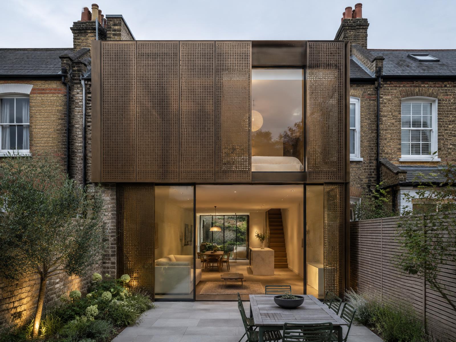 Edwardian terrace house with a two-storey bronze perforated screen and glass rear addition