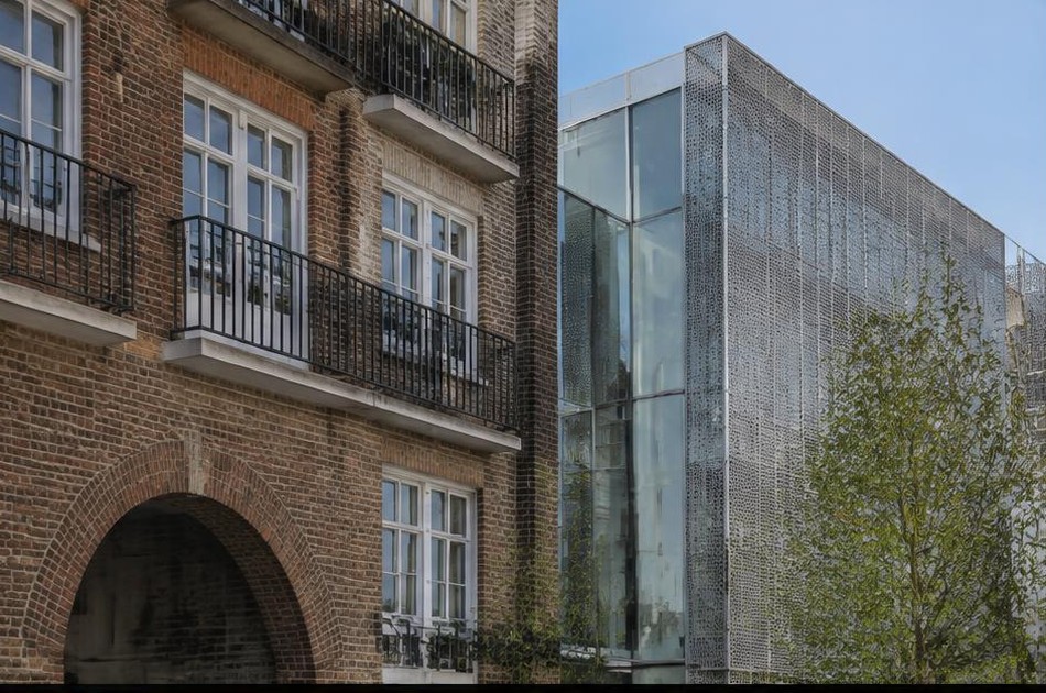 Retained original facade beside a dominant contemporary addition in Somers Town