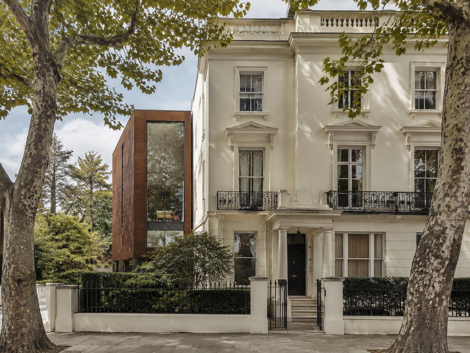 White stucco South Kensington villa with a corten steel and glass contemporary side extension