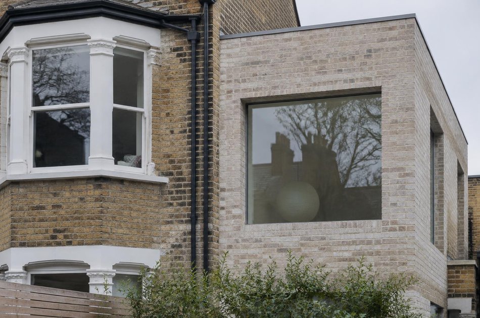 Edwardian bay window beside a pale brick extension in South Wimbledon