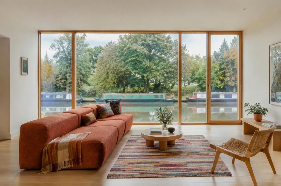 Living room with full-height glazing over the canal in Southall