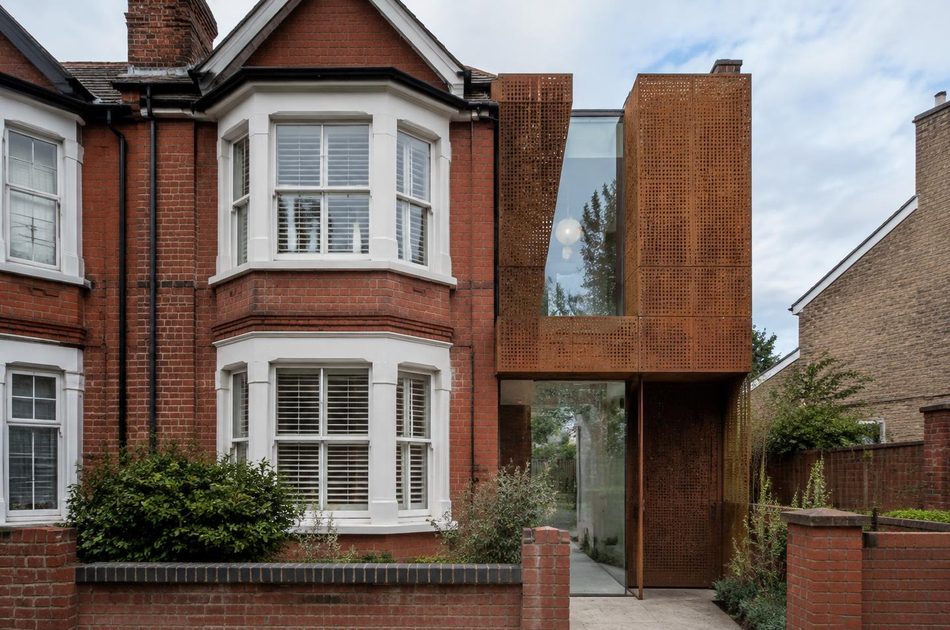 Edwardian terrace beside a perforated corten steel extension in Southall