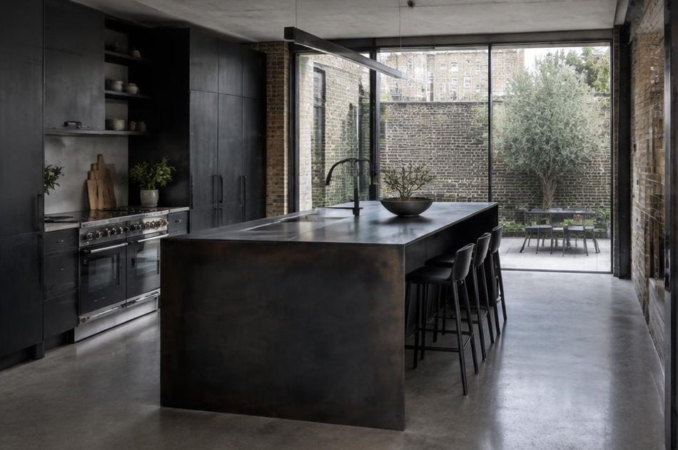 Contemporary kitchen with an open staircase and glazing onto a residential garden in Southwark