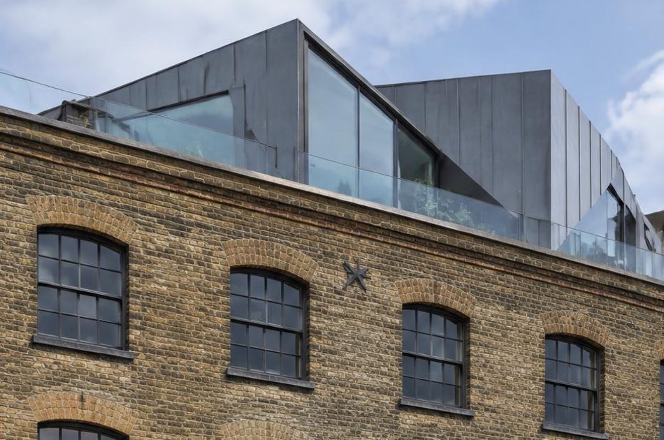 Retained historic facade directly beside a contemporary glazed residential addition in Southwark