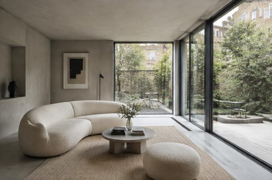Minimalist contemporary room with straight fabric seating and views onto Southwark residential homes and gardens