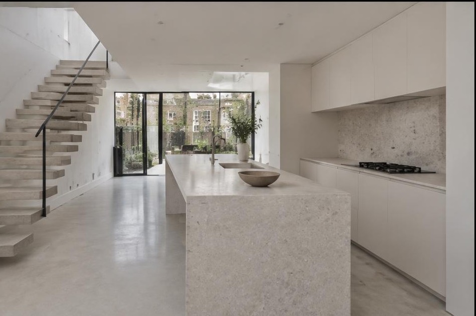 Completed contemporary kitchen with open staircase and garden glazing in Spitalfields