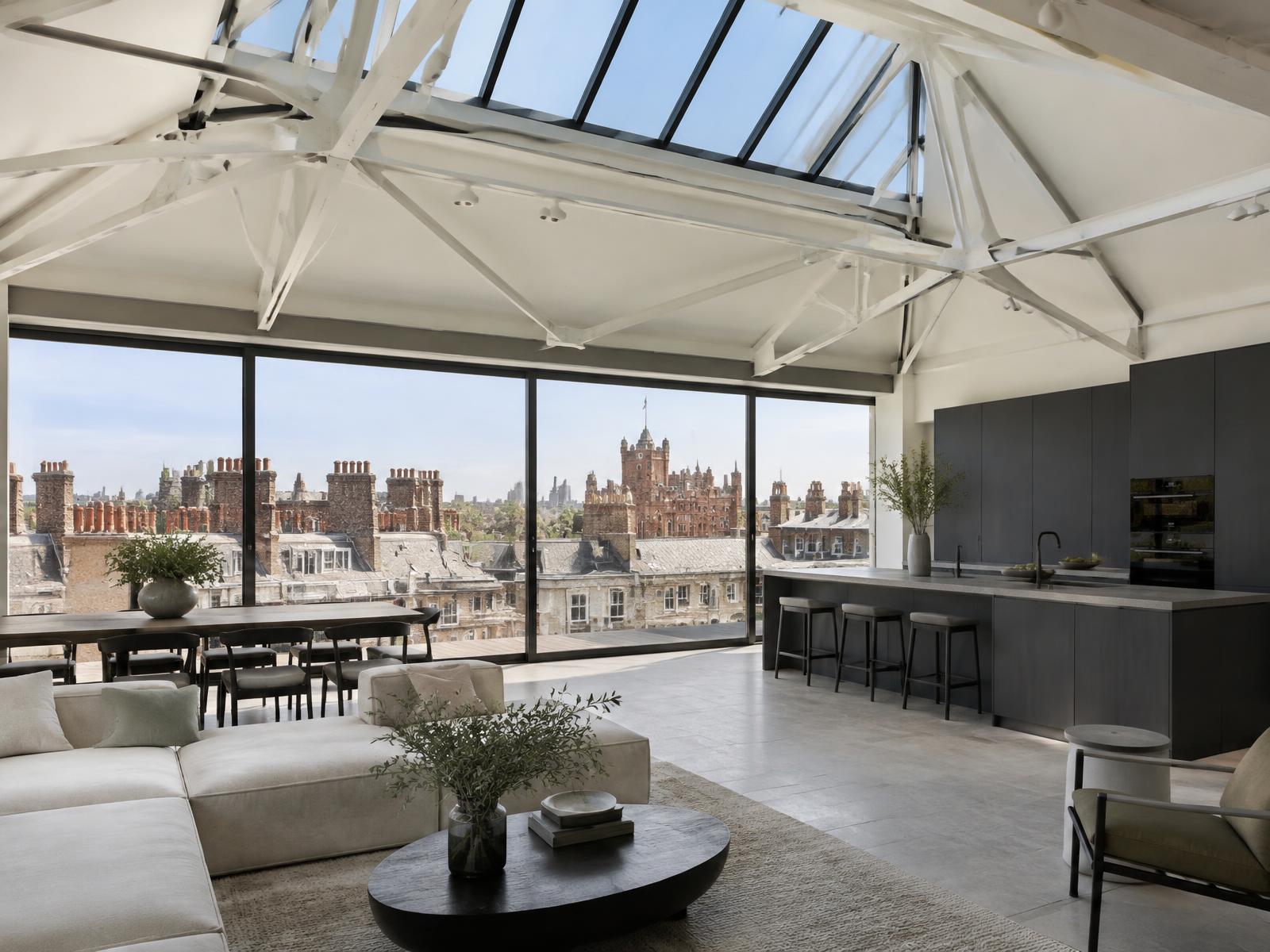 New top-floor space with white steel trusses and full-width glazing over St James's rooftops toward St James's Palace