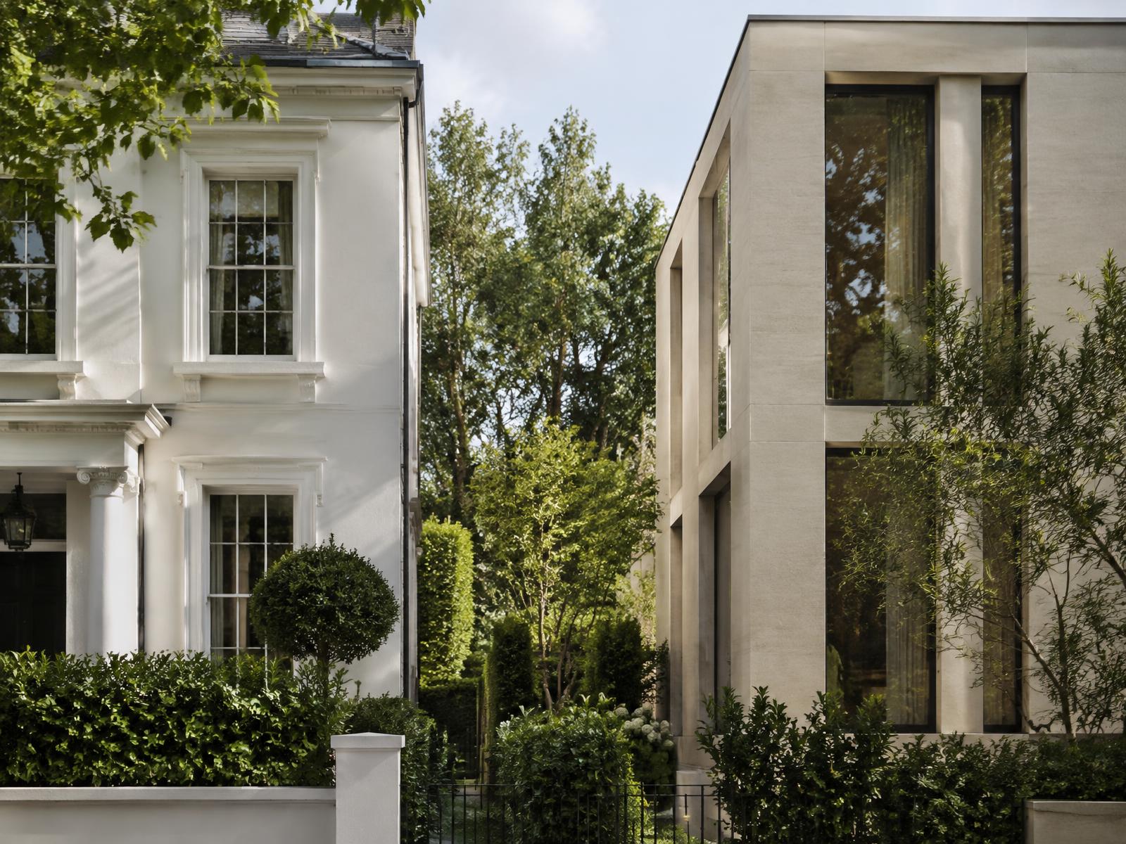 White stucco villa beside a contemporary limestone villa with garden space kept open between them in St John's Wood