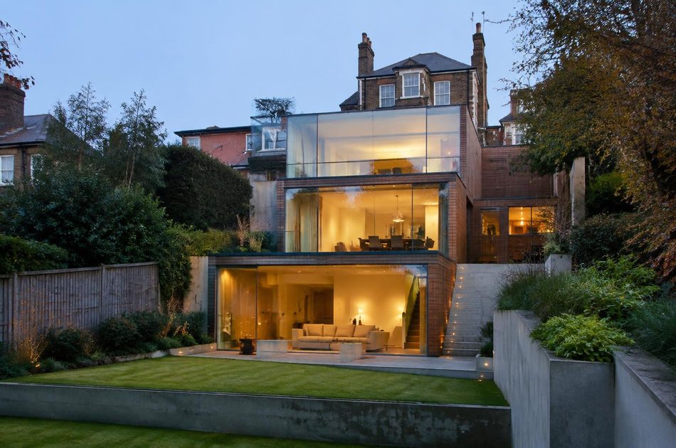 Stepped glass and brick extension built into a sloping garden in Sydenham