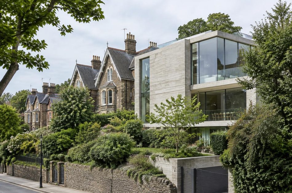 Leafy hillside street of Victorian Gothic villas beside a contemporary concrete and glass house in Sydenham