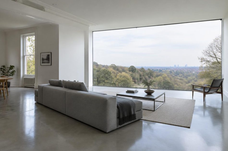 Living room with full-height glazing over wooded hillside in Sydenham