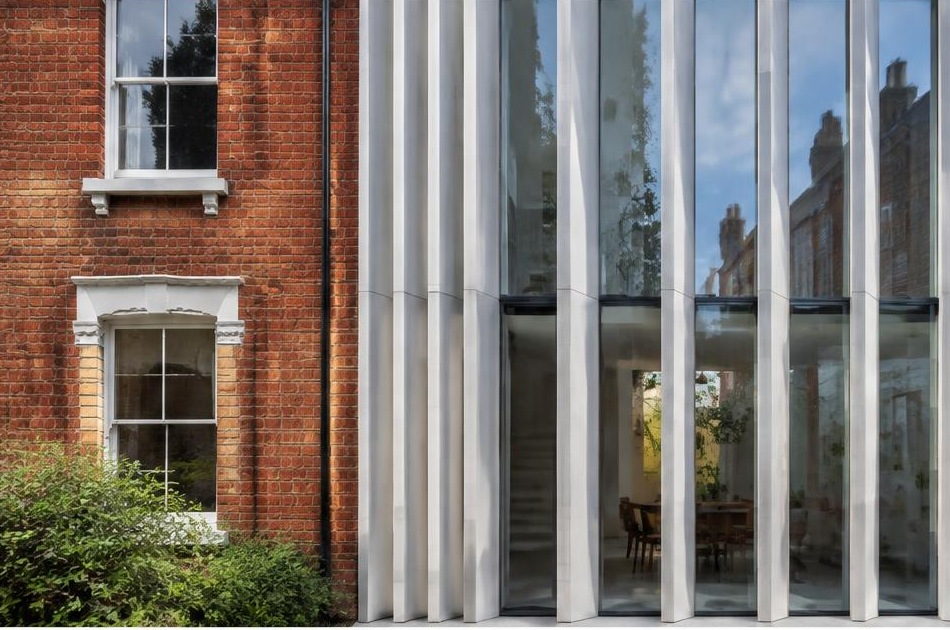 Retained historic facade directly beside a contemporary glazed residential addition in Tooting