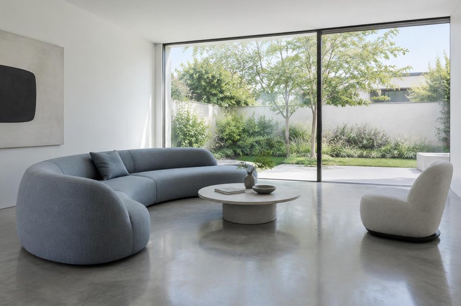 Living room with a curved sofa opening onto a garden in Tottenham Hale