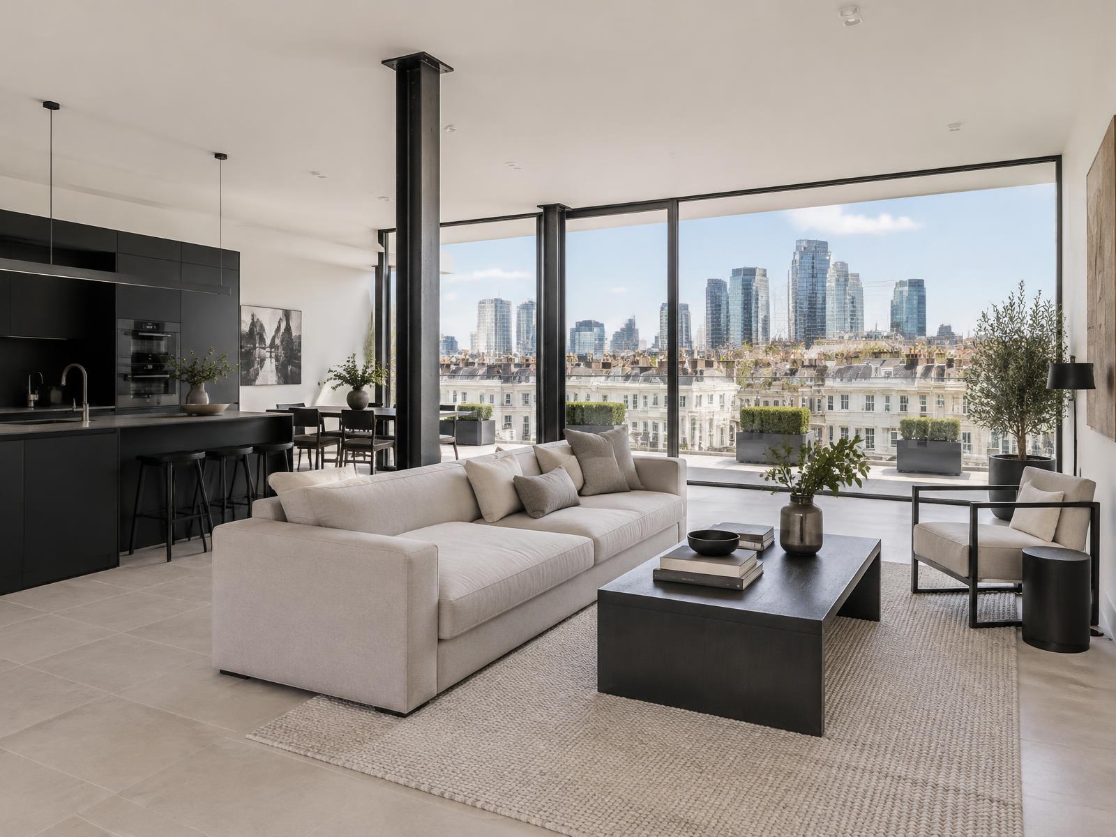 New penthouse living space with steel columns and full-width glazing over Victoria's stucco rooftops