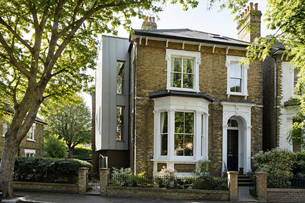 Victorian villa with a slim zinc-clad side addition in Wanstead