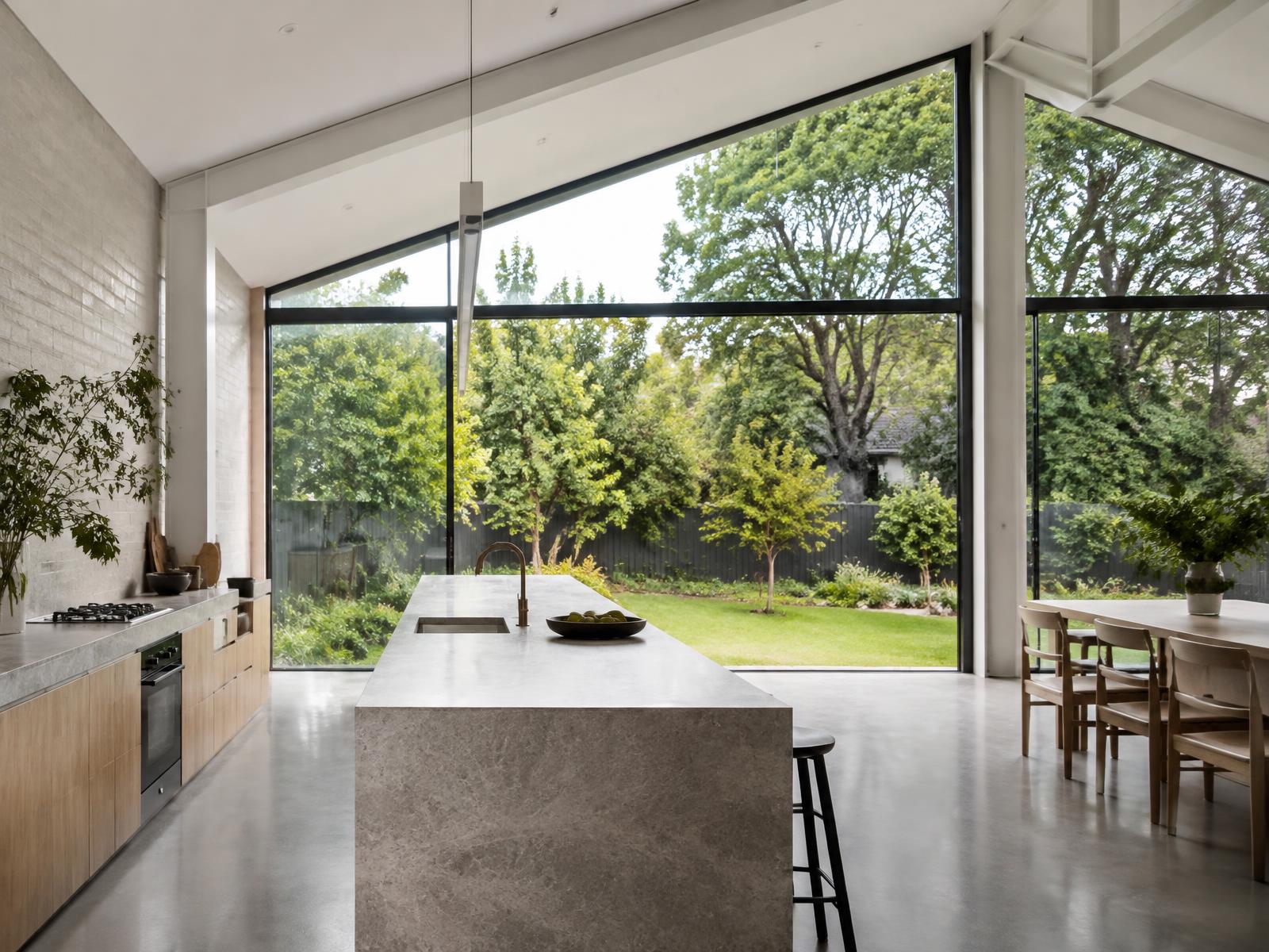 New rear extension with a full-height gable window onto a garden and mature trees