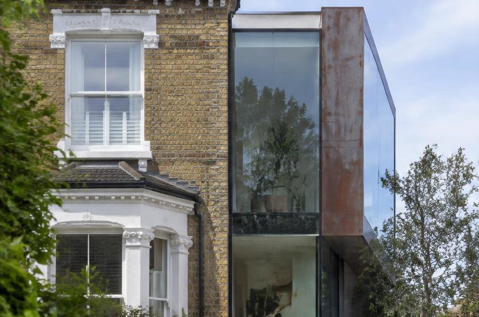 Retained historic facade directly beside a contemporary glazed residential addition in West Norwood