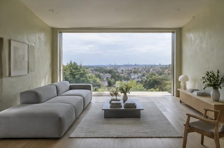 Minimalist contemporary room with straight fabric seating and views onto West Norwood residential homes and gardens