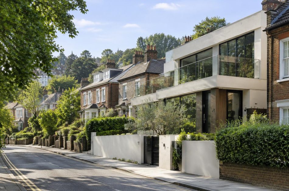 Hillside street of Victorian villas beside a contemporary white house near Wimbledon Village