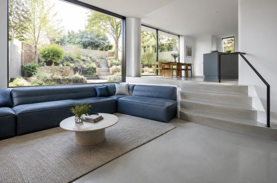 Contemporary living space opening onto a garden in Wimbledon Park