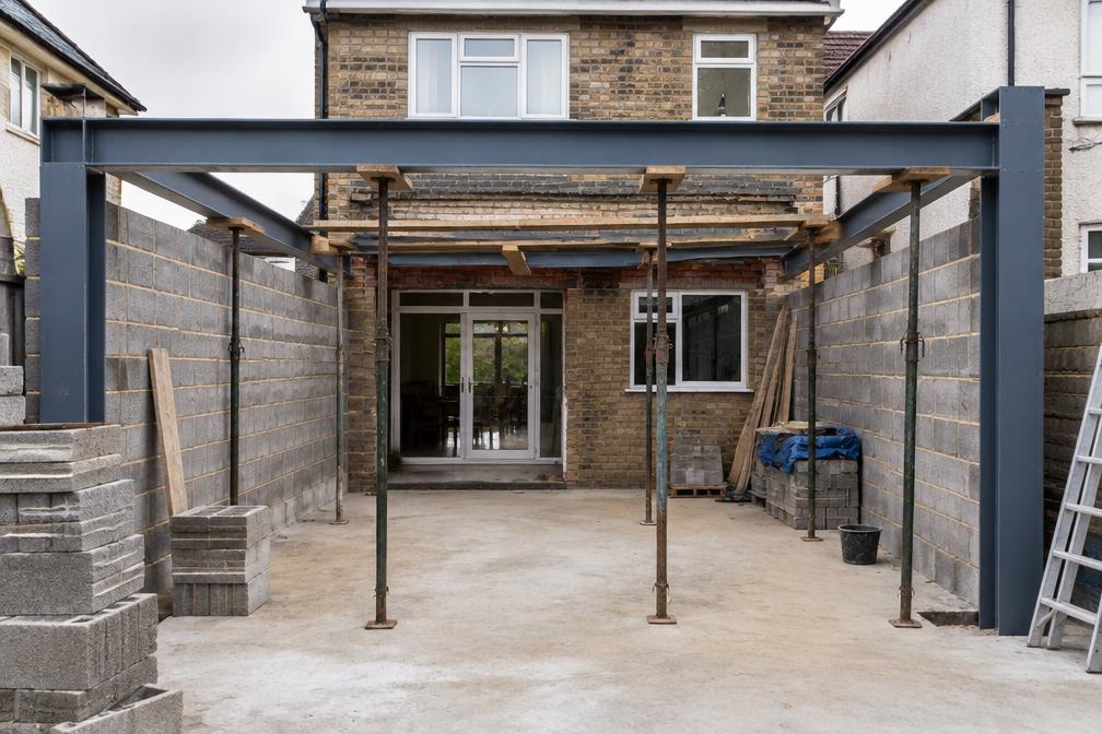 Steel goalpost frame being installed for an open-plan rear extension