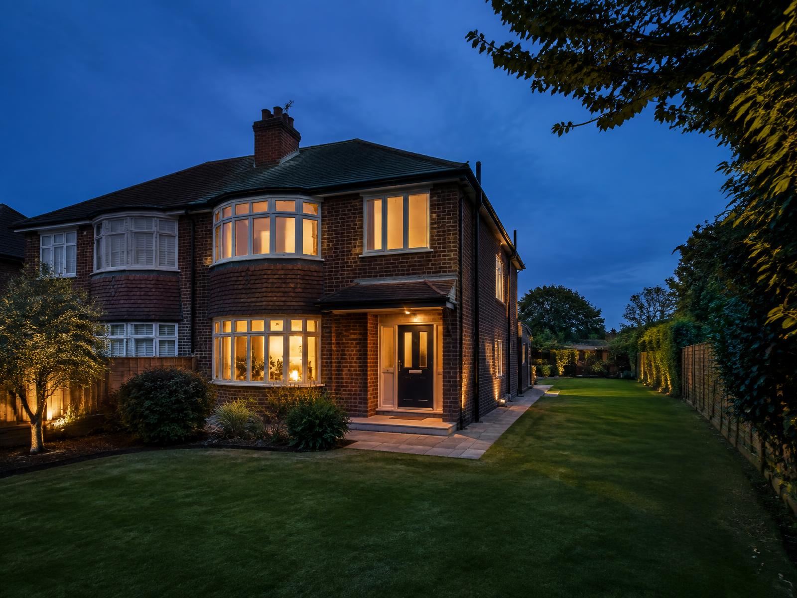 Generic London semi-detached property with a large garden and side return at blue hour
